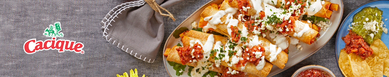 Cacique food items arranged on a table with branded packaging visible.