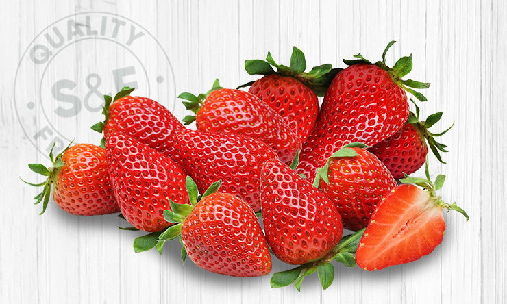 Close-up of ripe strawberries with textured seeds and leafy green tops, vibrant red in color”