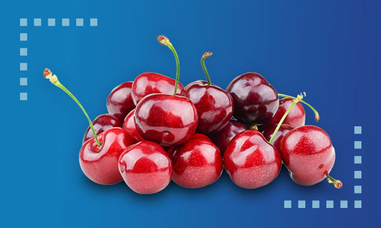 Cluster of glossy red Northwest cherries with green stems, arranged in a small pile against a smooth blue gradient background with subtle dotted graphic accents.